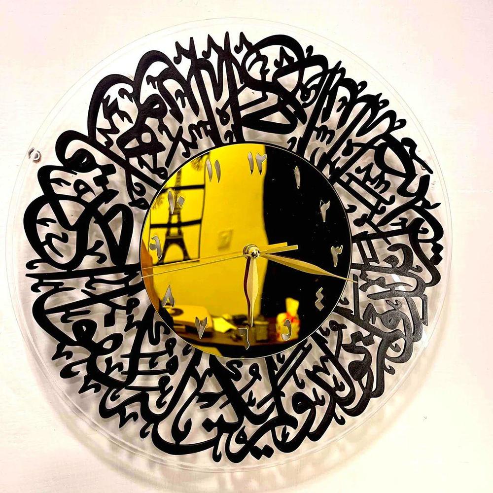 Decorative wall clock with black calligraphy design on a white background